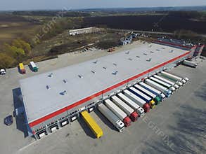 Aerial view of goods warehouse. Logistics center in industrial city zone from above.