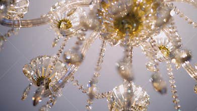 Beautiful close-up of a chandelier hanging from the ceiling. Bottom view. The lighting device shimmers with beautiful lights.