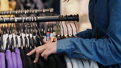 Woman choosing clothes on the rack