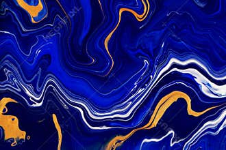 Hand painted background with mixed liquid blue and golden paints. Abstract fluid acrylic painting. Modern art. Marbled