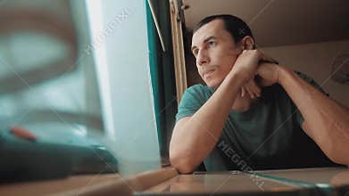 Man travel rides train lifestyle railway looks out the window. traveler concept train railroad journey travel. slow