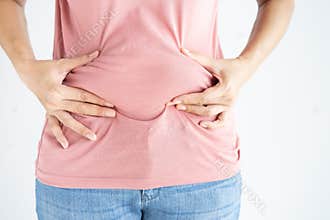Woman hand holding her own belly fat and cellulite white background. Women before weight loss and shape up healthy stomach