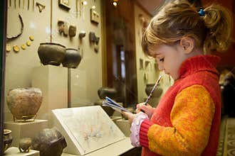 Girl writes to writing-books at excursion