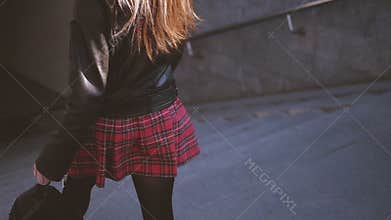 Stylish chic urban blonde woman descending subway