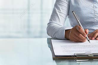 Businesswoman signing paper