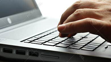 Closeup male hands typing keyboard computer laptop backlit 4k footage