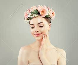 Young pretty woman with clear healthy skin and flowers, spa beauty portrait