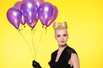 lady with a bunch of purple balloons