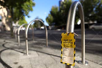 Out of service tag attached on faulty defect hand ascender do not operation on bike rack public park