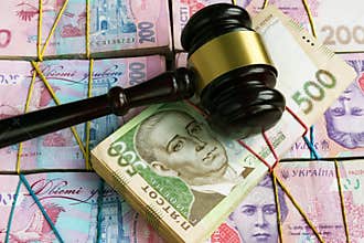 Bribes and corruption in Ukrainian court. Gavel on stacks of hryvnia