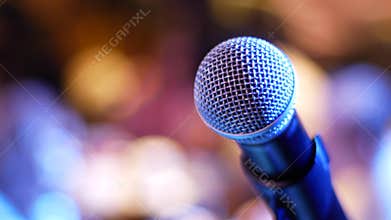 Microphone on a blue-violet and yellow-orange background