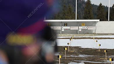 Close-up of the athlete shoots at the target. Sport biathlon