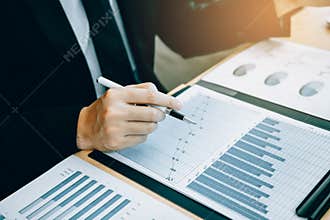 Close up of hand investors are using calculators to calculate the company`s earnings to invest in stocks for future profits