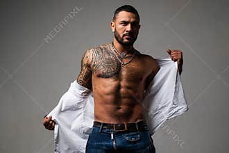 Confidence charisma. muscular macho man with athletic body. sport and fitness, health. sexy abs of tattoo man. male