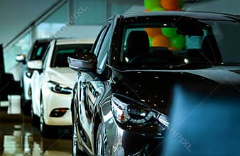 New luxury shiny compact car parked in modern showroom. Car dealership office. Car retail shop. Electric car technology