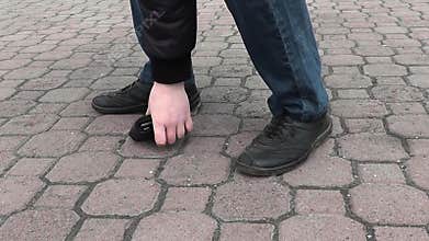 A man found a wallet on the road in the park and picked it up