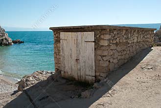 Small garages, for fishermen`s boats, on the west bank of Istria