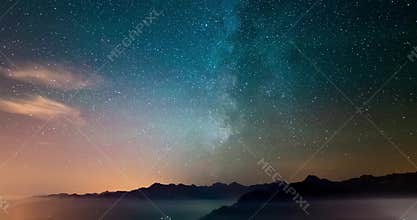 Astro Time Lapse Milky way and stars rotating over the Alps with fog and clouds