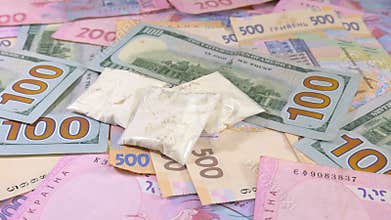 Drugs and cash money everywhere on a table. Closeup shot.