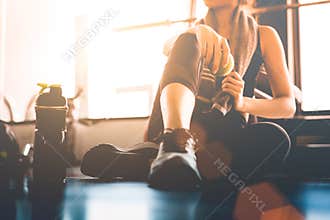 Sport woman sitting and resting after workout or exercise in fit