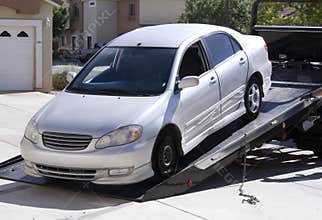 Tow-truck picking up broken down car