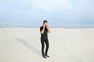 Husband speaking on smartphone with wife walking at seaside sm