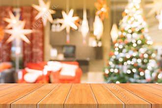 Wooden board empty table top on of blurred background. Perspective brown wood table over blur christmas tree background.