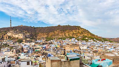 Bundi cityscape, travel destination in Rajasthan, India. The majestic fort perched on mountain slope overlooking the blue city. W