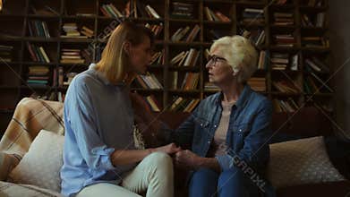 Elderly mother supporting her daughter at home