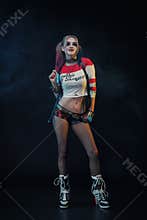 Cosplayer girl with in Harley Quinn costume. Halloween make up