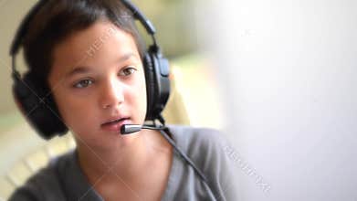 Child playing on the computer with headphones