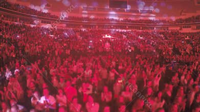 Crowd of fanatic religious sect members applauding to preacher, red illumination