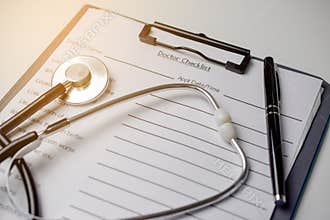 Doctor check list with stethoscope and pen