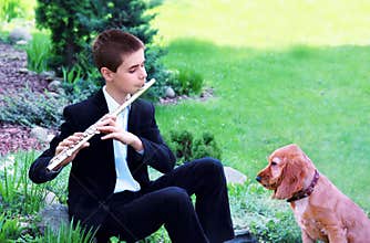Teenage Boy with Flute and Dog