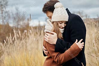 Couple in love walking in the Park, Valentine`s day. A man and a woman embrace and kiss, a couple in love, tender feelings