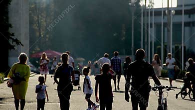 Silhouettes of adults and children riding bicycles, families with baby strollers