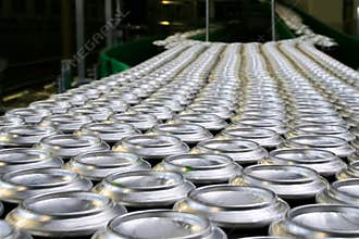 Thousands of beverage aluminum cans on conveyor line at factory