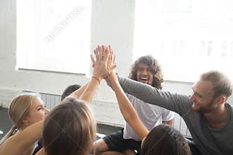 Group of young sporty people giving a high five