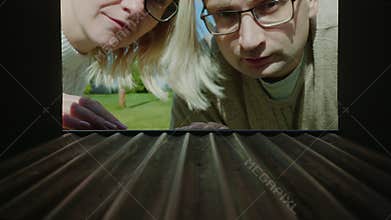 A married couple looks in an empty mail box, upset - no letters