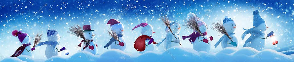 Many snowmen standing in winter Christmas landscape.