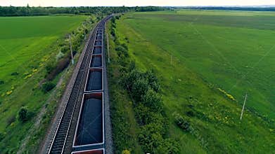 Big cargo train transporting coal. Aerial shot. Close-up.
