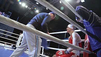 LVIV, UKRAINE - November 14, 2017 Boxing tournament. Coach instructs boxer between rounds.