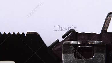 Thank you words in block letters on a sheet of paper. Close up