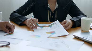 Business man and woman meeting and consult about business and marketing plan with infographic graph bar pi document on wooden tabl