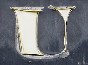 Worn, shabby letter `U` from the advertisement