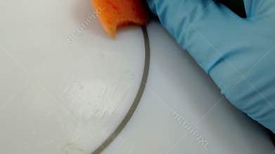 Macro of washing dirty induction stove.