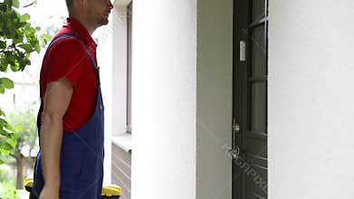 Handyman repairman walk to a client house with tool box