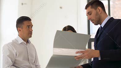 Realtor with folder showing documents to customers