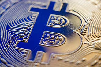 Bitcoin coin currency closeup on blue backlight