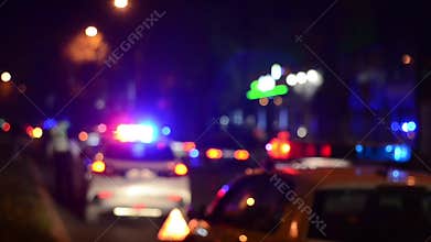 Traffic police officers works on the street. Policeman at work. Police emergency lights flash at night. Car accident. Crime scene.